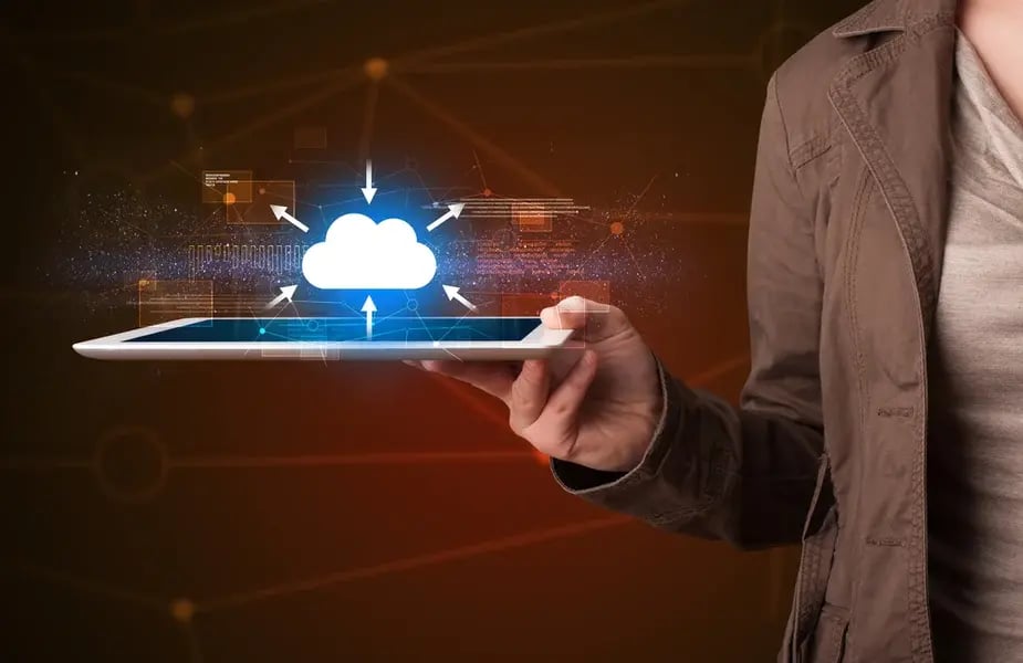 Casual young woman holding tablet with cloud concept